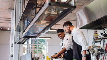 Two chefs in the kitchen cooking