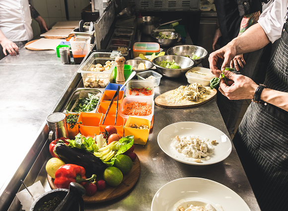 Chef plating dishes on expo station